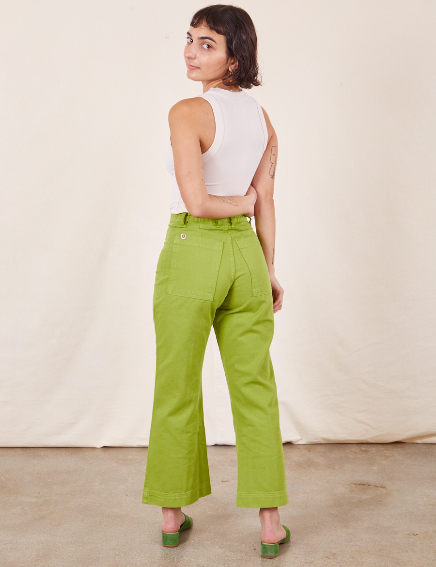 Back view of Western Pants in Gross Green paired with vintage off-white Tank Top worn by Soraya