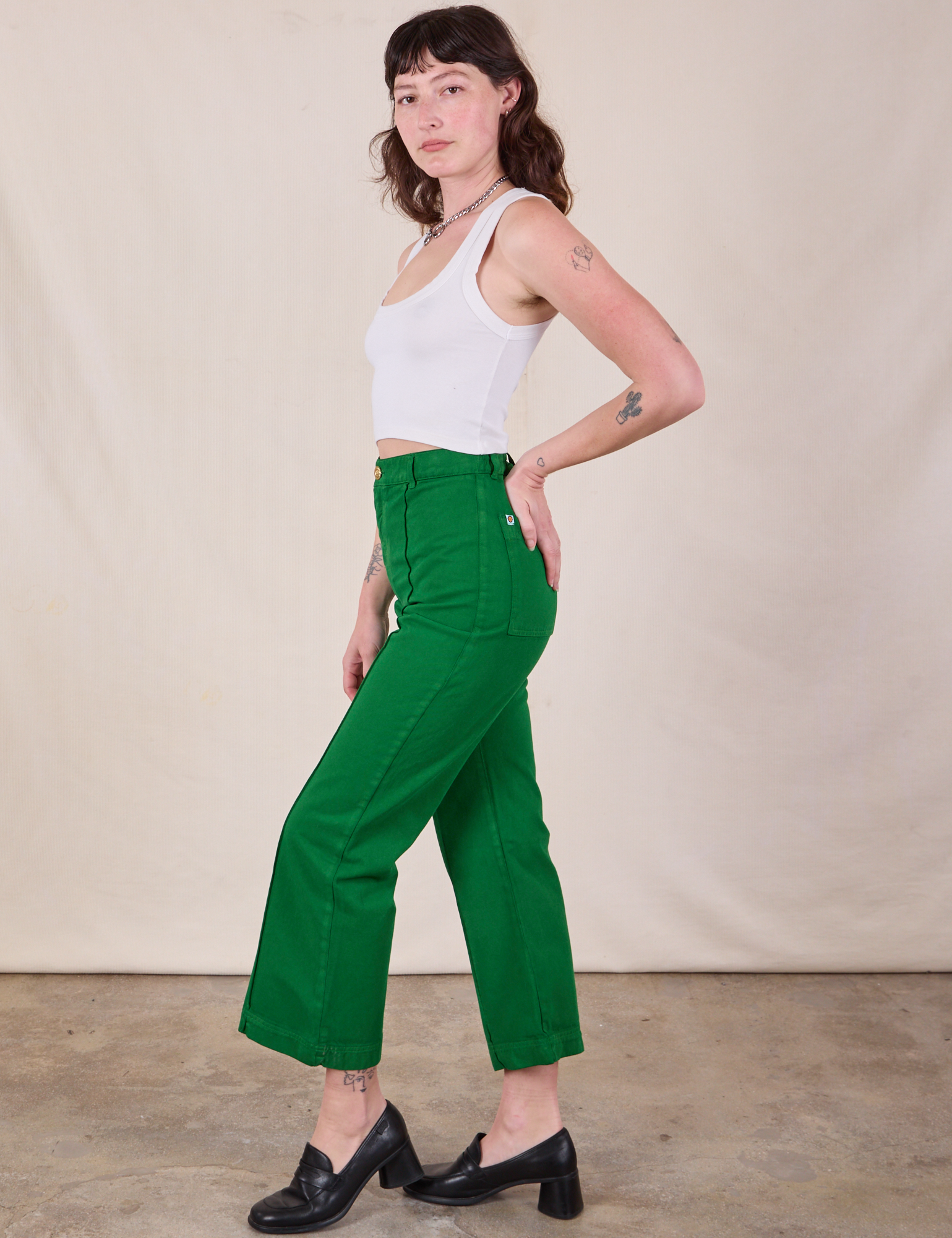 Side view of Western Pants in Forest Green and Cropped Tank in Vintage Tee Off-White on Alex