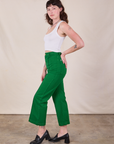 Side view of Western Pants in Forest Green and Cropped Tank in Vintage Tee Off-White on Alex