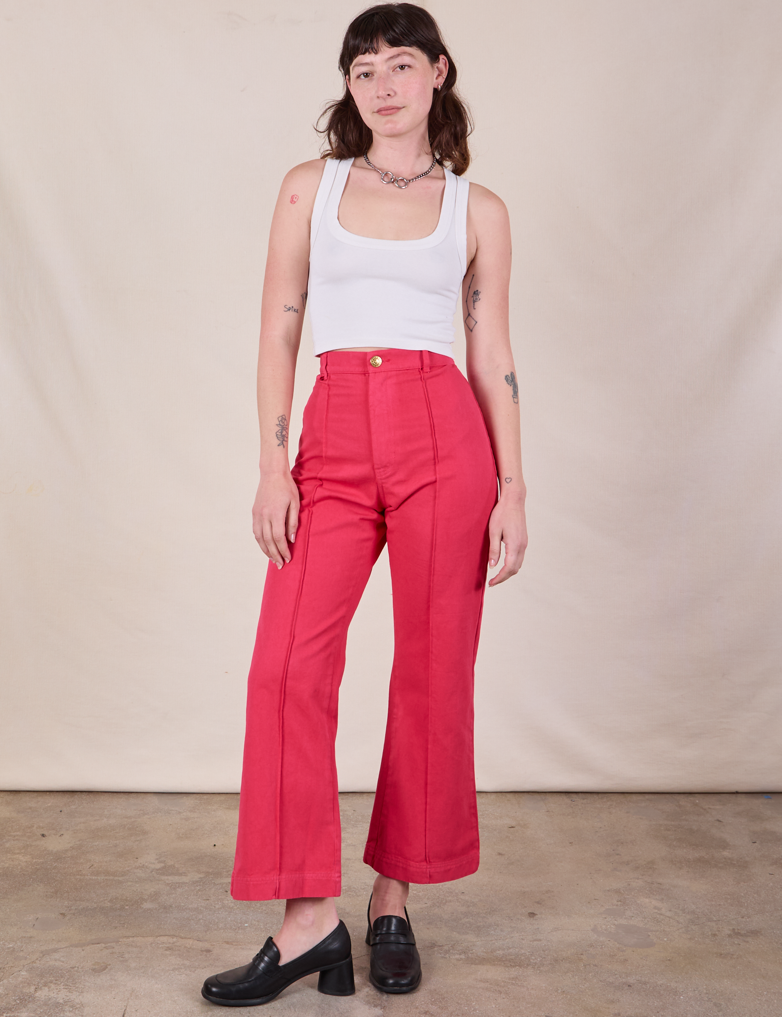 Alex is 5&#39;8&quot; and wearing XS Western Pants in Hot Pink paired with a Cropped Tank in Vintage Tee Off-White