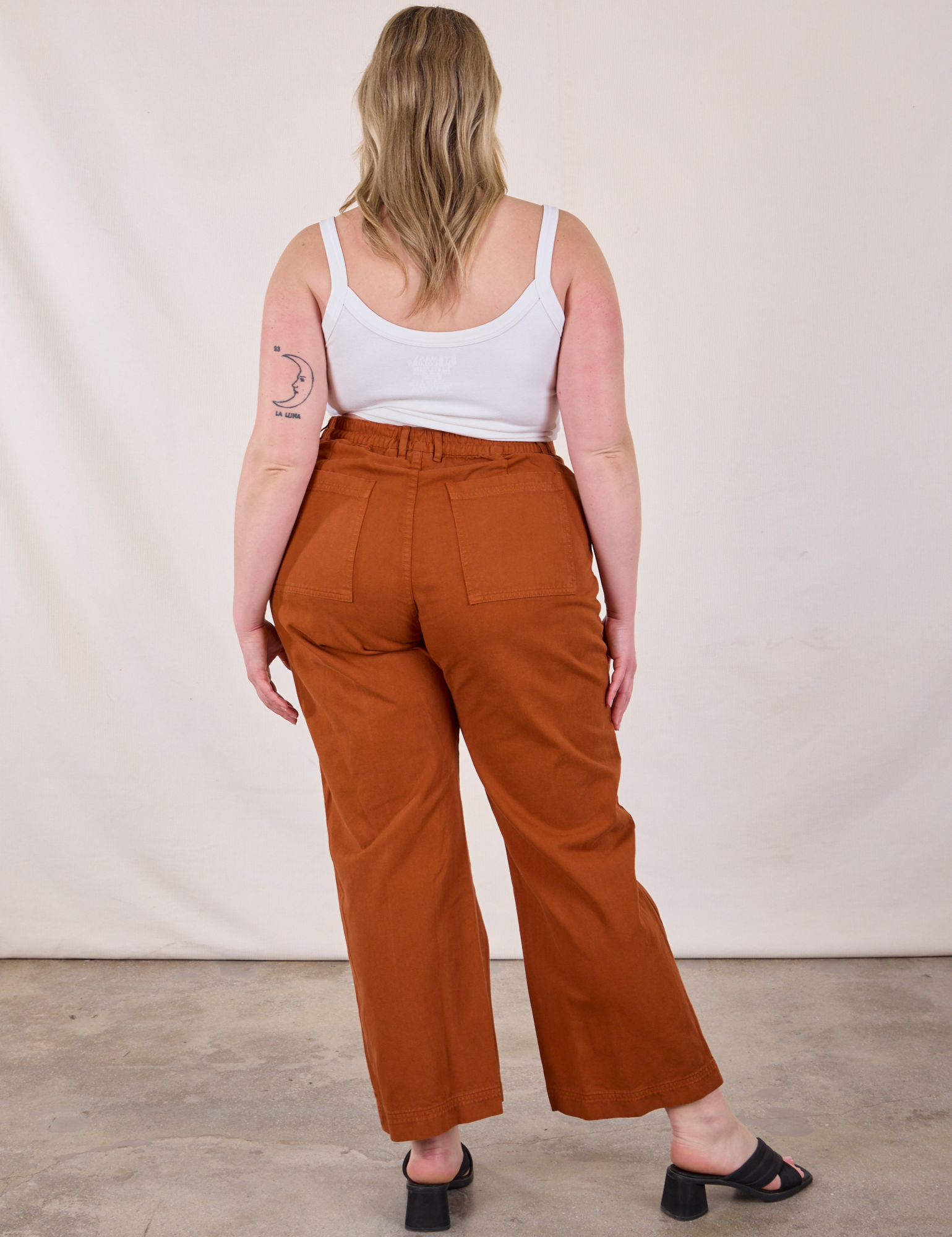 Back view of Western Pants in Burnt Terracotta and Cropped Cami in Vintage Tee Off-White worn by Lish