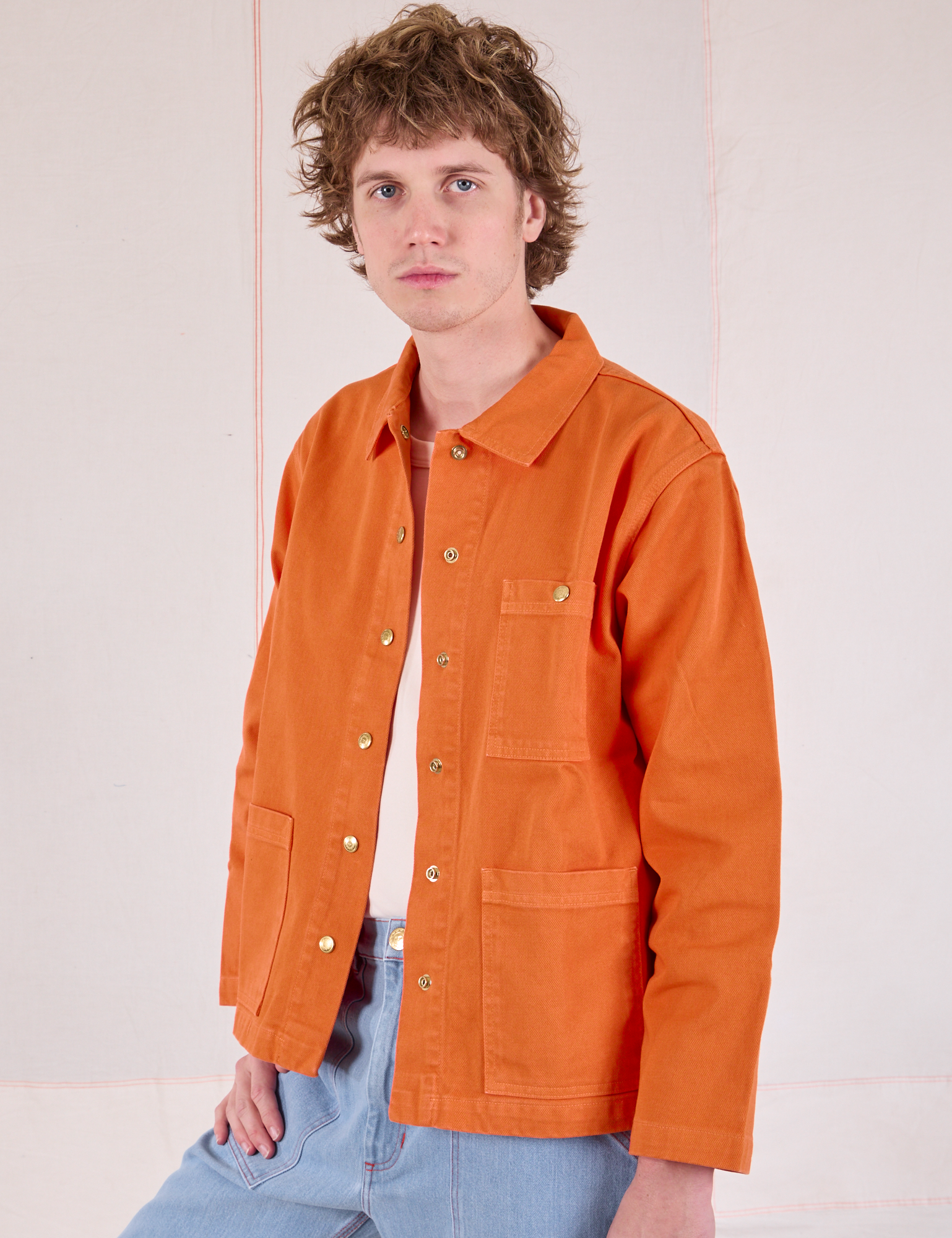 Denim Work Jacket in Construction Orange angled front view on Quinn