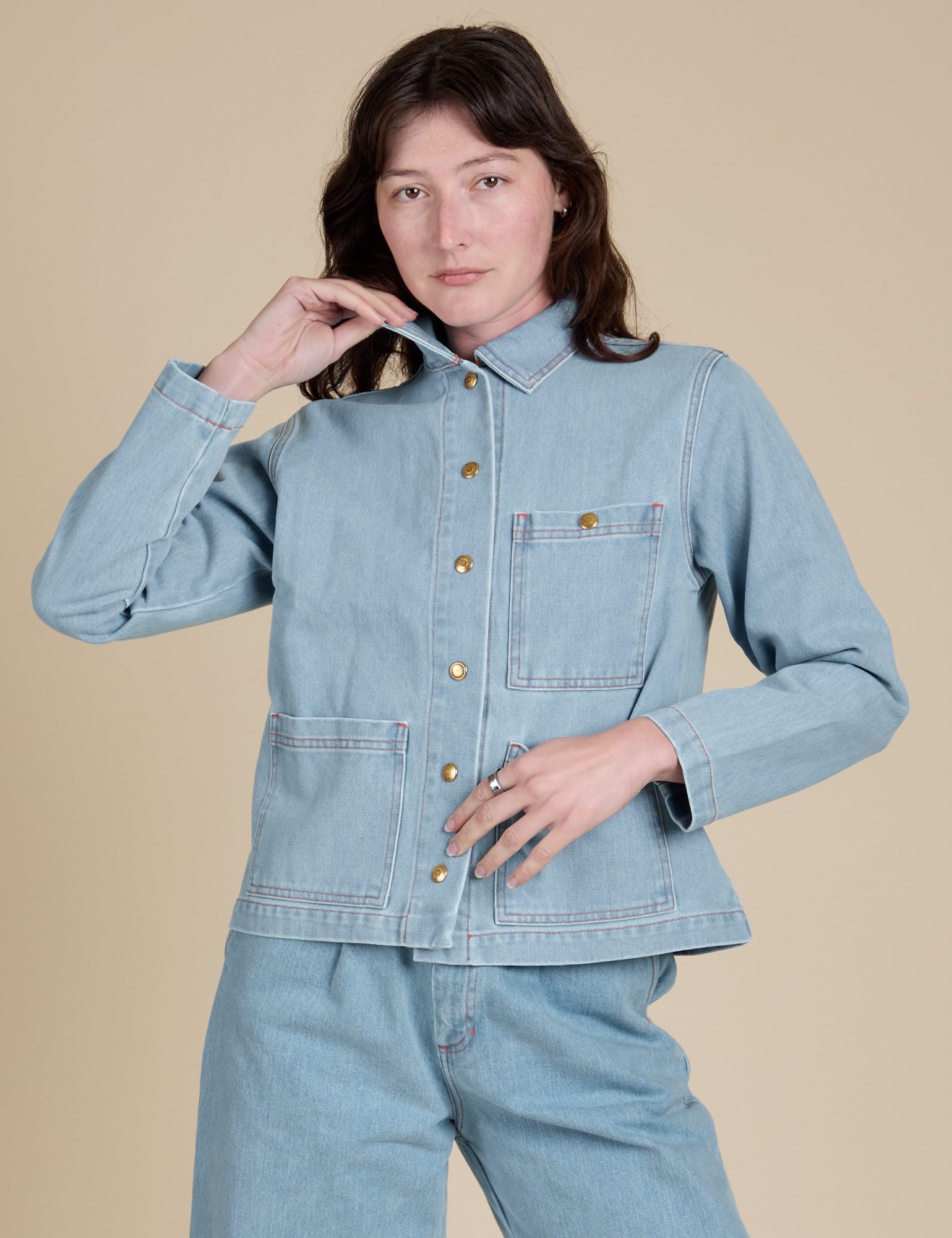 Alex is wearing a buttoned up Indigo Denim Work Jacket in Light Wash