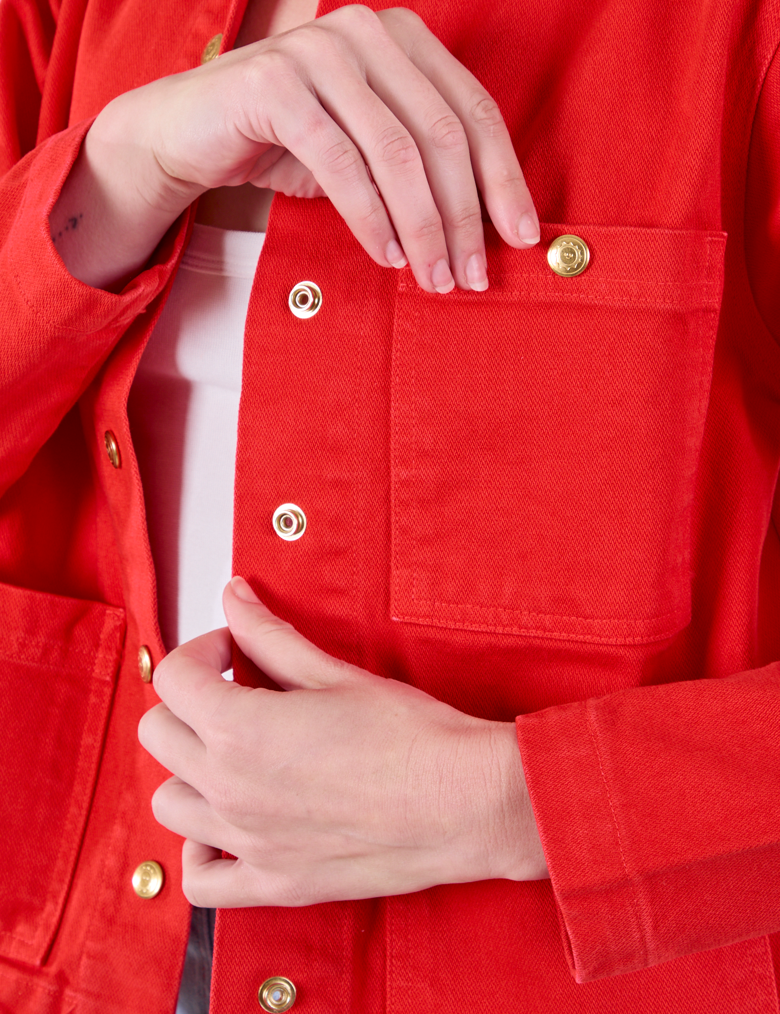 Denim Work Jacket in Mustang Red front pocket close up on Alex