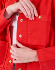 Denim Work Jacket in Mustang Red front pocket close up on Alex