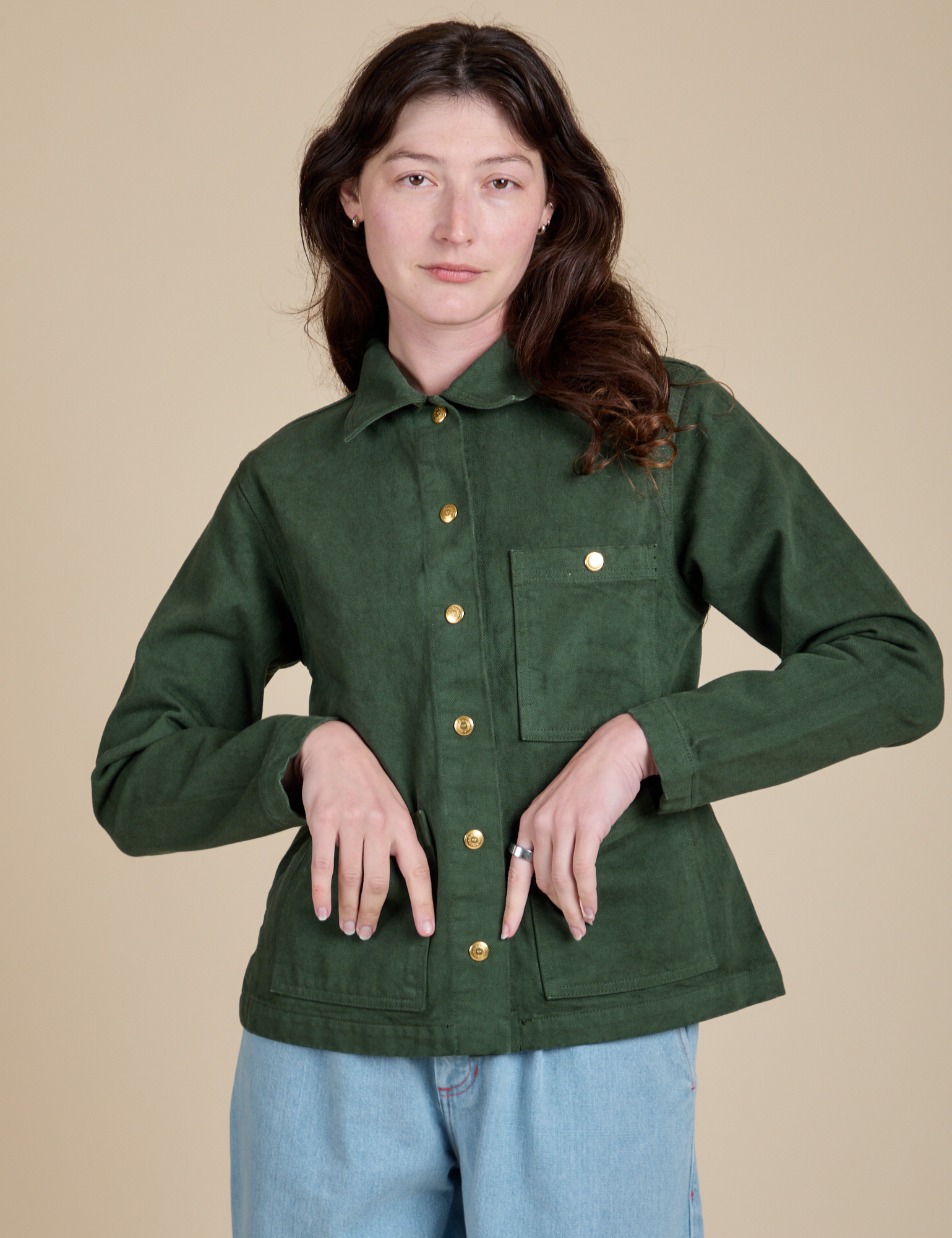 Alex is wearing a buttoned up Denim Work Jacket in Swamp Green