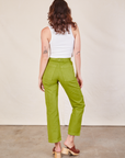 Back view of Work Pants in Gross Green and Cropped Tank in vintage tee off-white on Alex