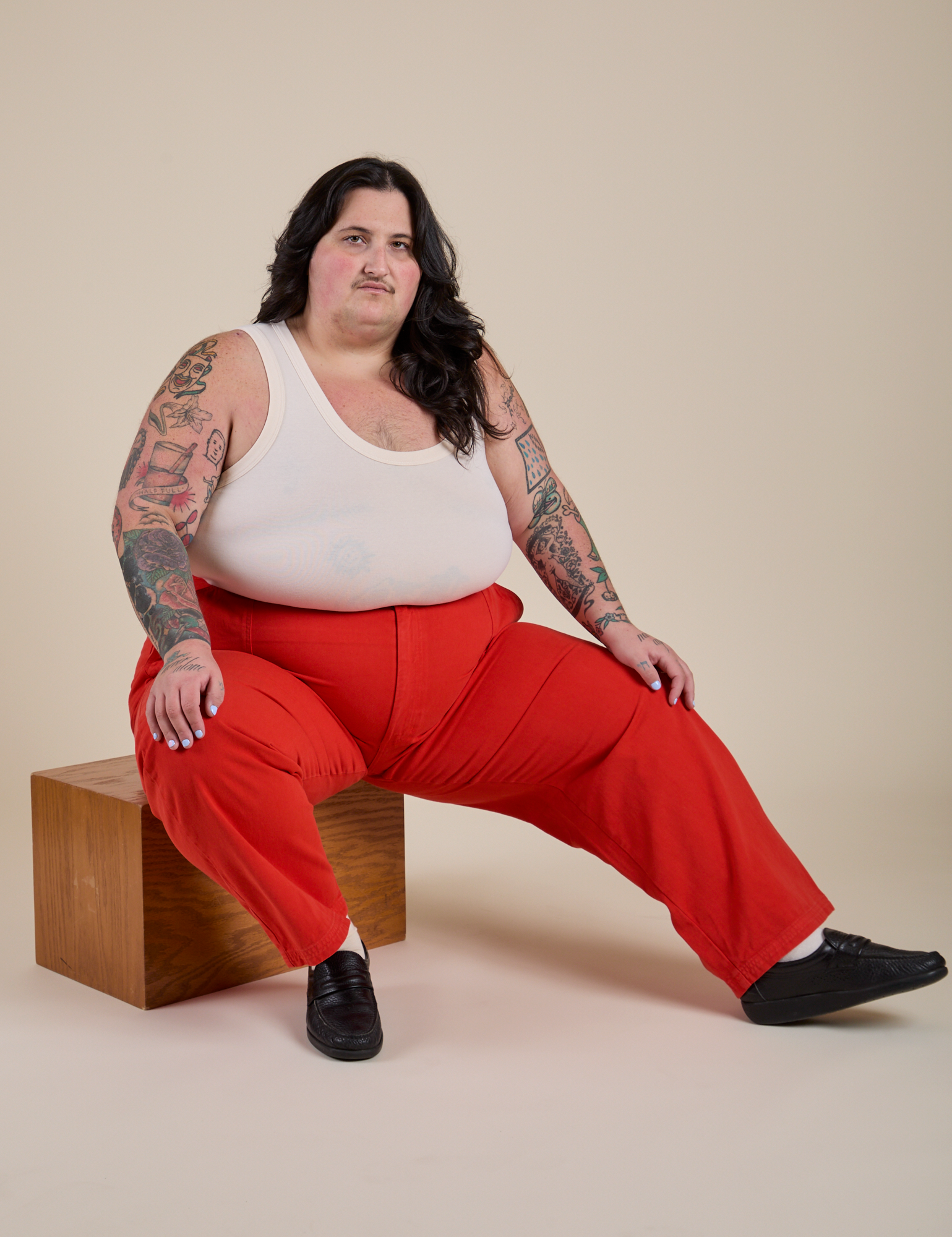 Work Pants in Mustang Red and vintage tee white Cropped Tank on Sam