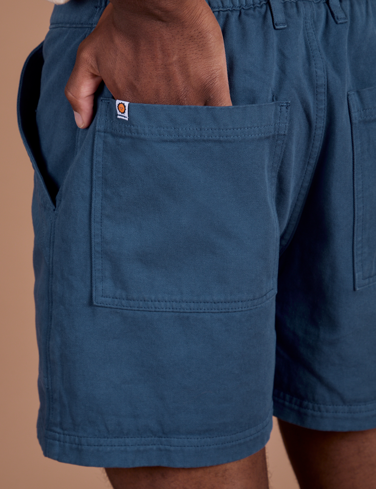 Close up of Isaac's hand in the back pocket of Classic Work Shorts in French Blue