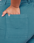 Classic Work Shorts in Marine Blue back pocket close up. Morgan has her hand in the pocket.