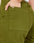 Classic Work Shorts in Summer Olive back pocket close up. Tiara has her hand in the pocket.