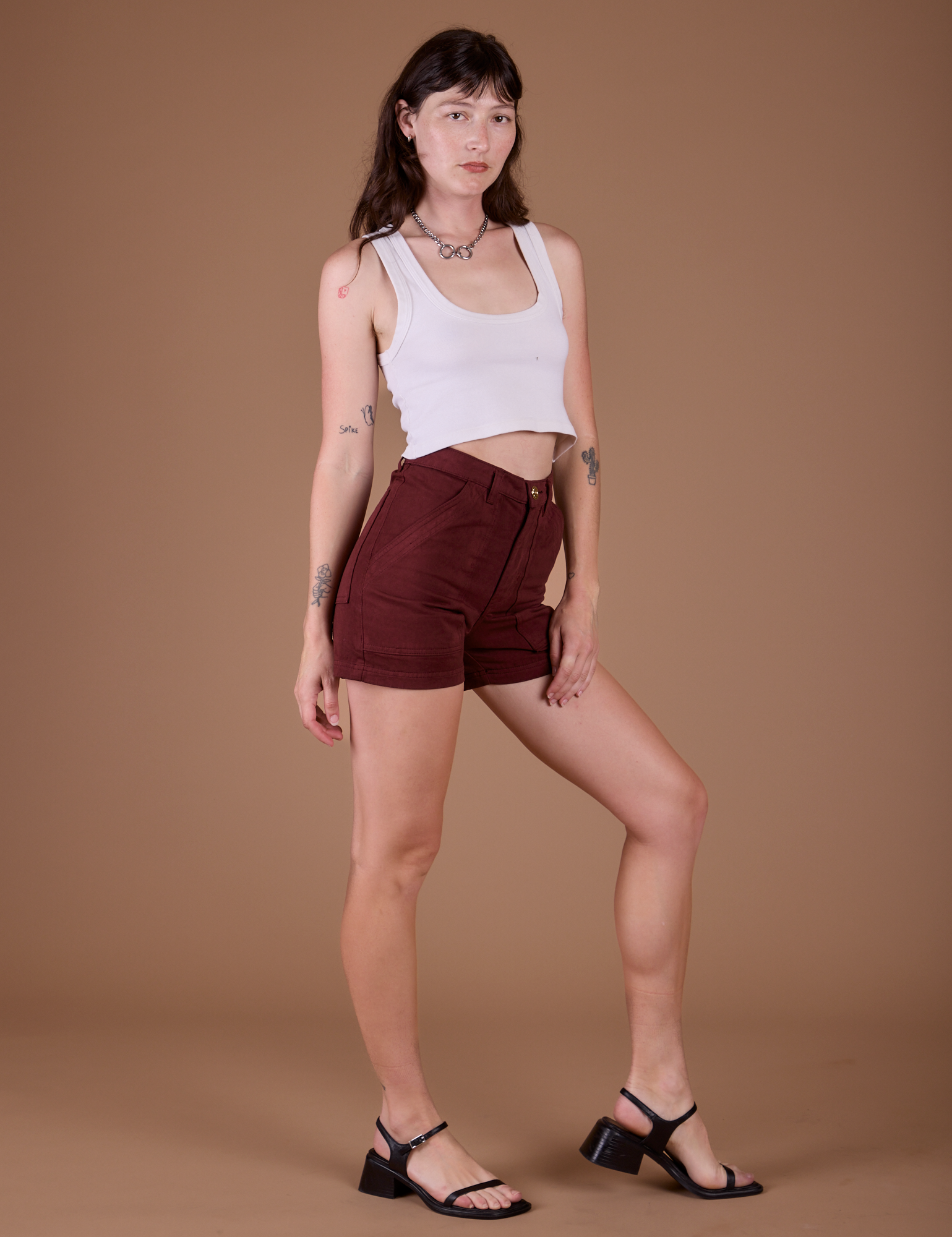 Angled front view of Classic Work Shorts in Red Wine and vintage tee white Cropped Tank on Alex