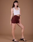 Angled front view of Classic Work Shorts in Red Wine and vintage tee white Cropped Tank on Alex