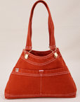 Overall Handbag in Paprika with handles standing up.