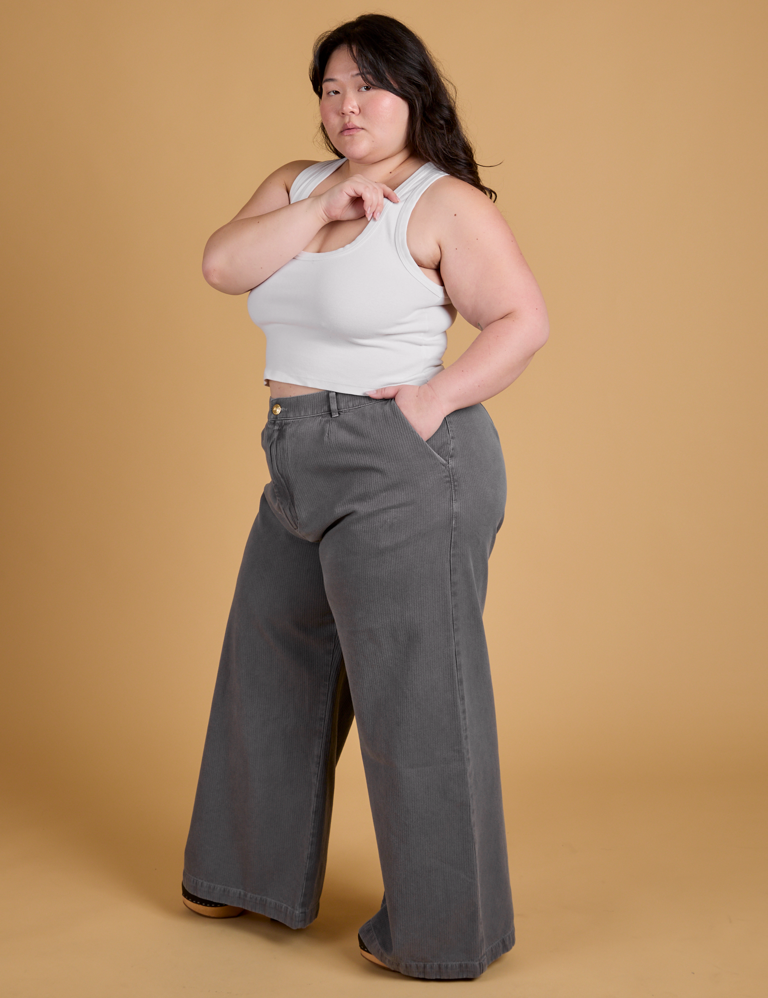 Side view of Heritage Wide Leg Trousers in Washed Grey and Cropped Tank in Vintage Tee White on Ashley