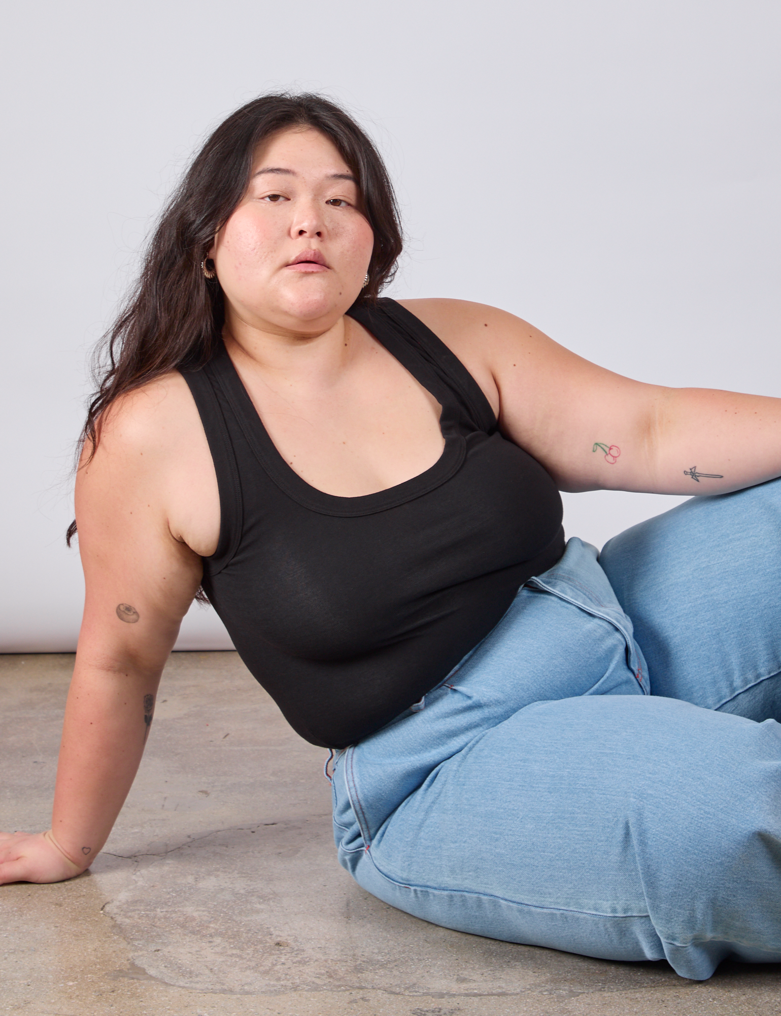 Ashley is wearing Cropped Tank Top in Basic Black