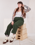 Sydney is wearing Action Pants in Swamp Green and Cropped Tank in vintage tee off-white