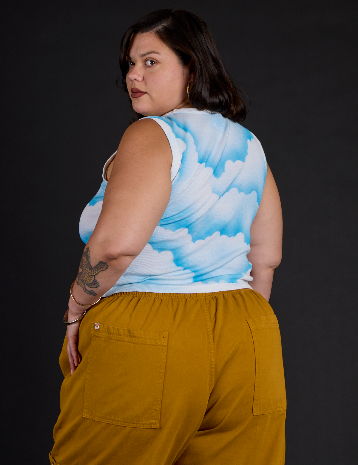 Angled back view of the Morning Moon Airbrush Muscle Tee on Kristen