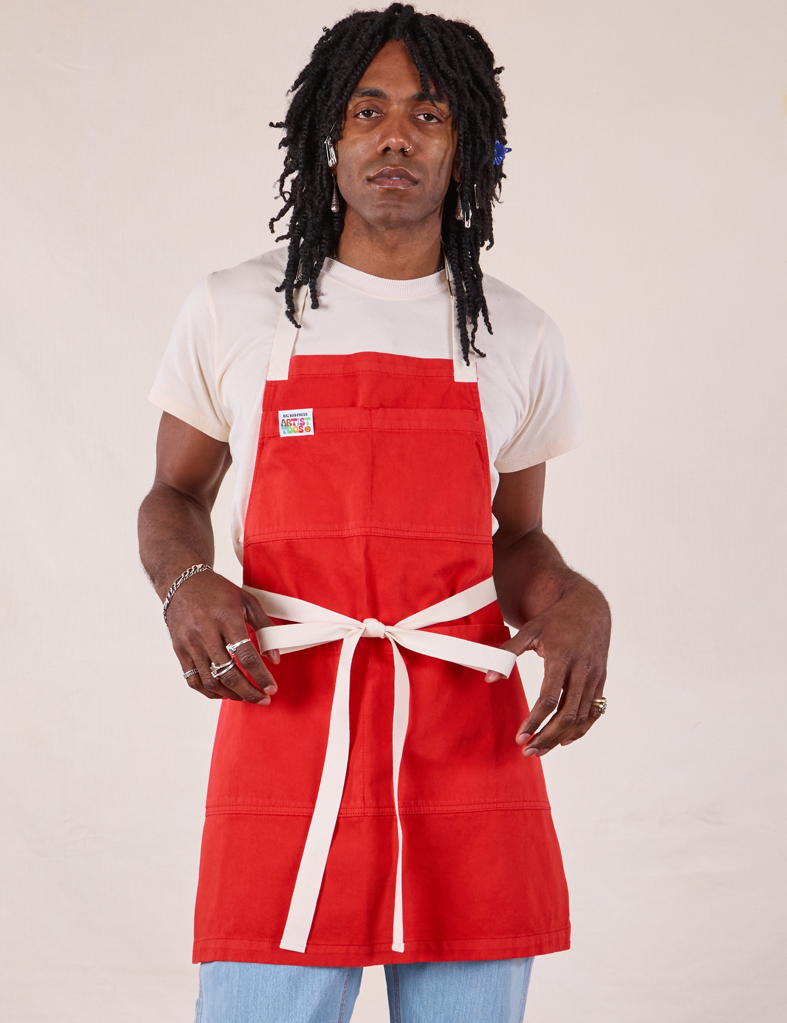 Jerrod is wearing Full Denim Apron in Mustang Red