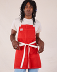 Jerrod is wearing Full Denim Apron in Mustang Red