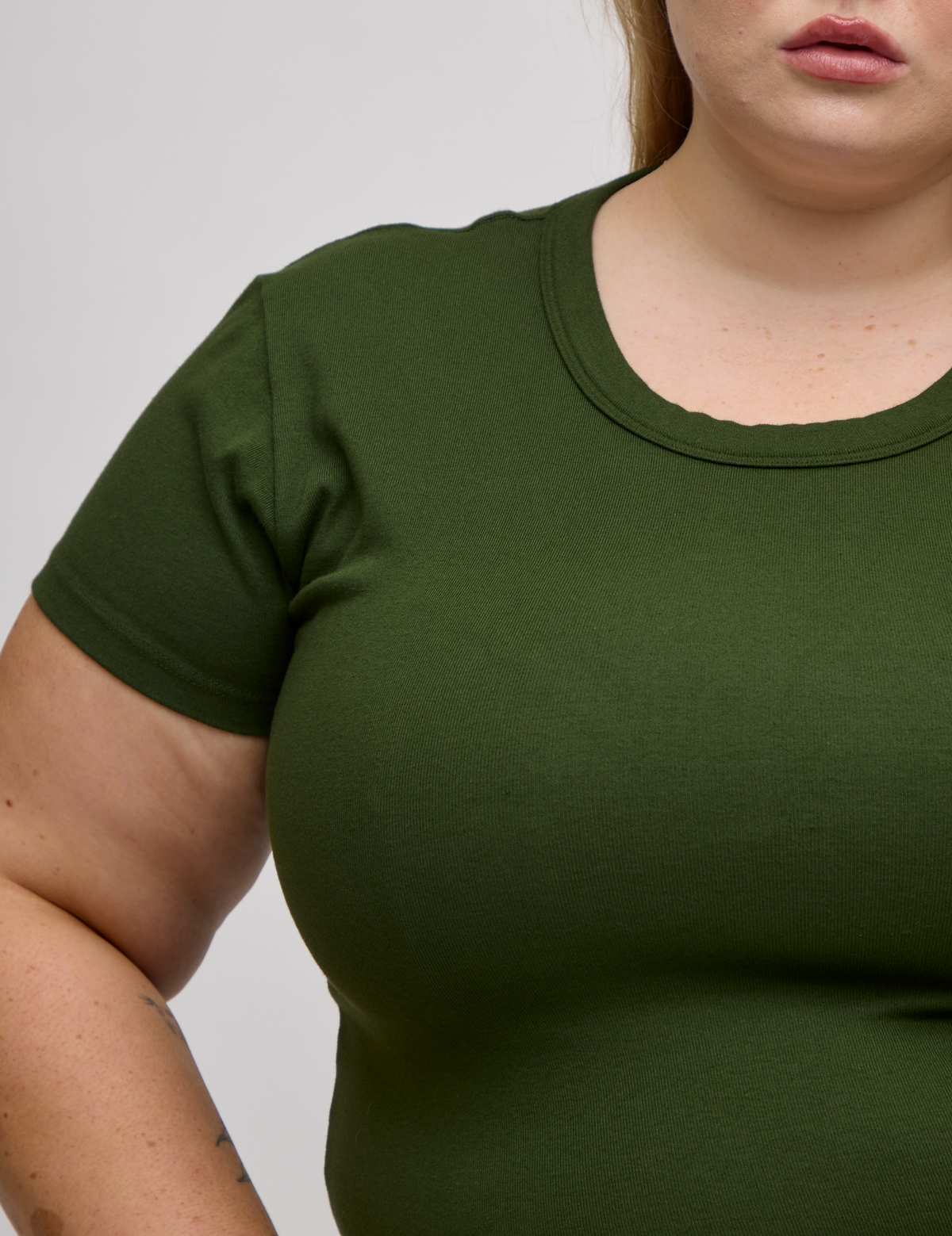 Front close up of Baby Tee in Evergreen on Juliet