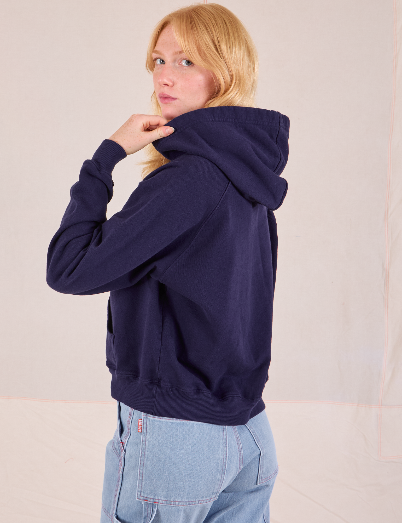 Collegiate Hoodie in Navy Blue angled back view on Margaret