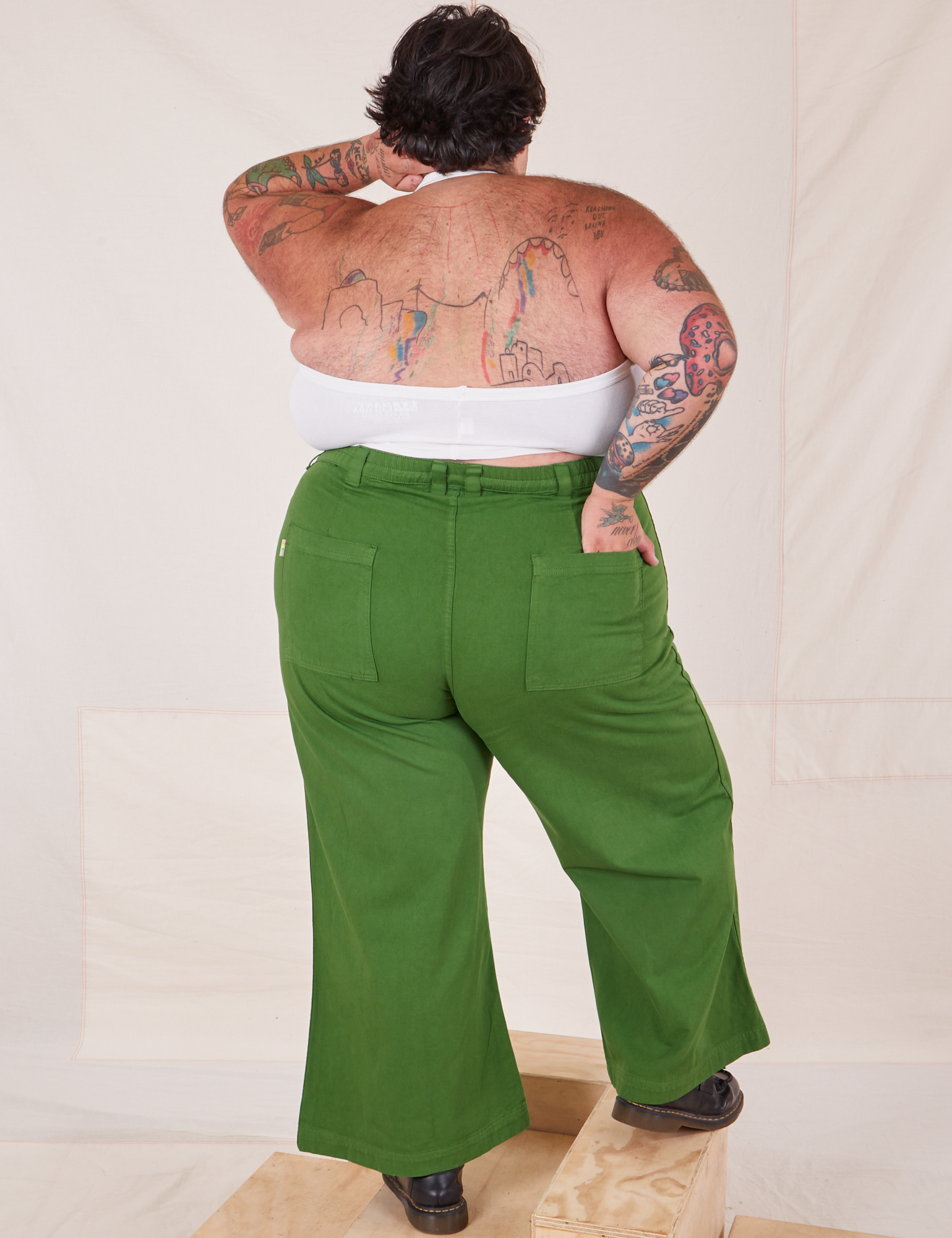 Back view of Bell Bottoms in Lawn Green and vintage off-white Halter Top on Sam