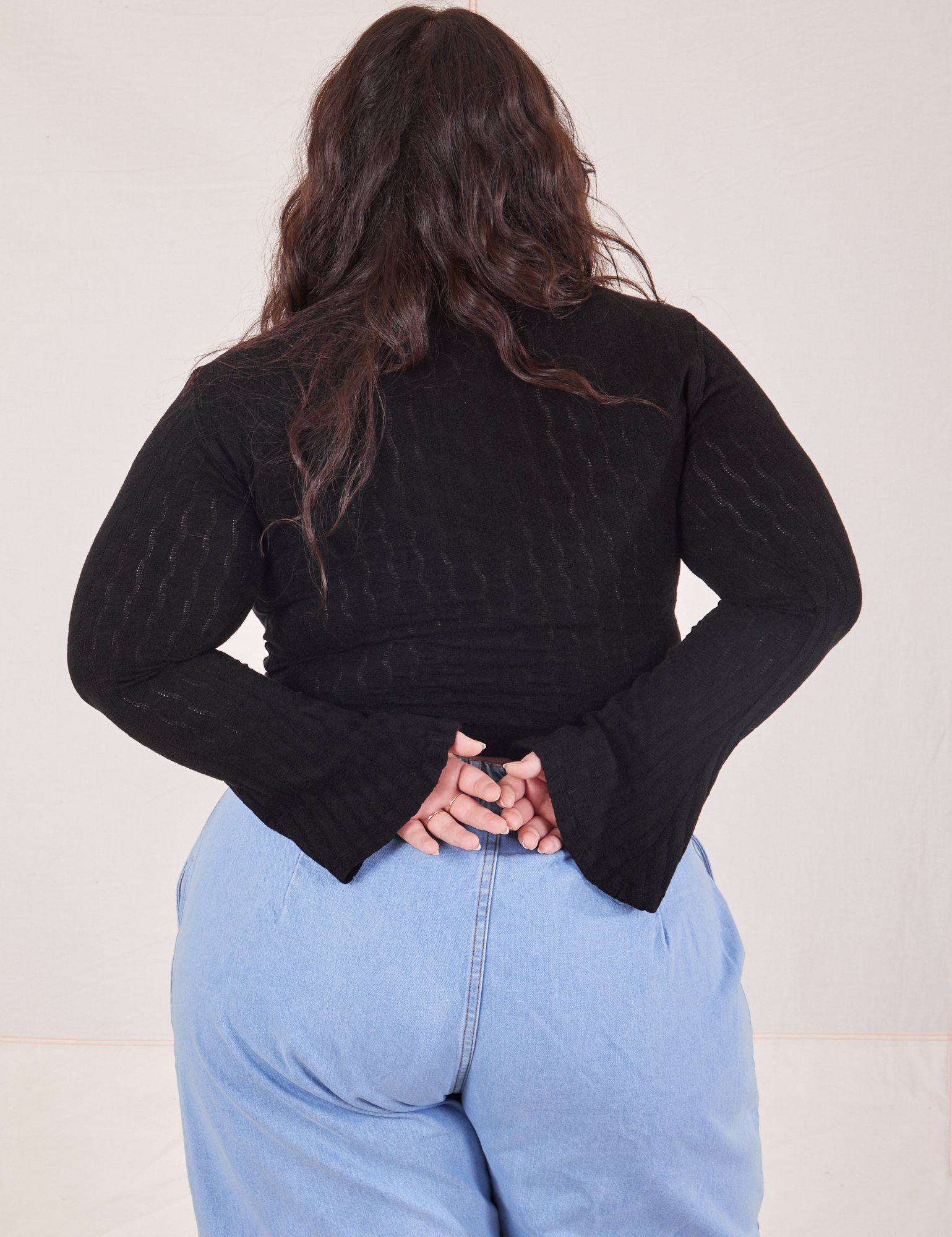 Back view of Bell Sleeve Top in Basic Black and light wash Trouser Jeans worn by Ashley