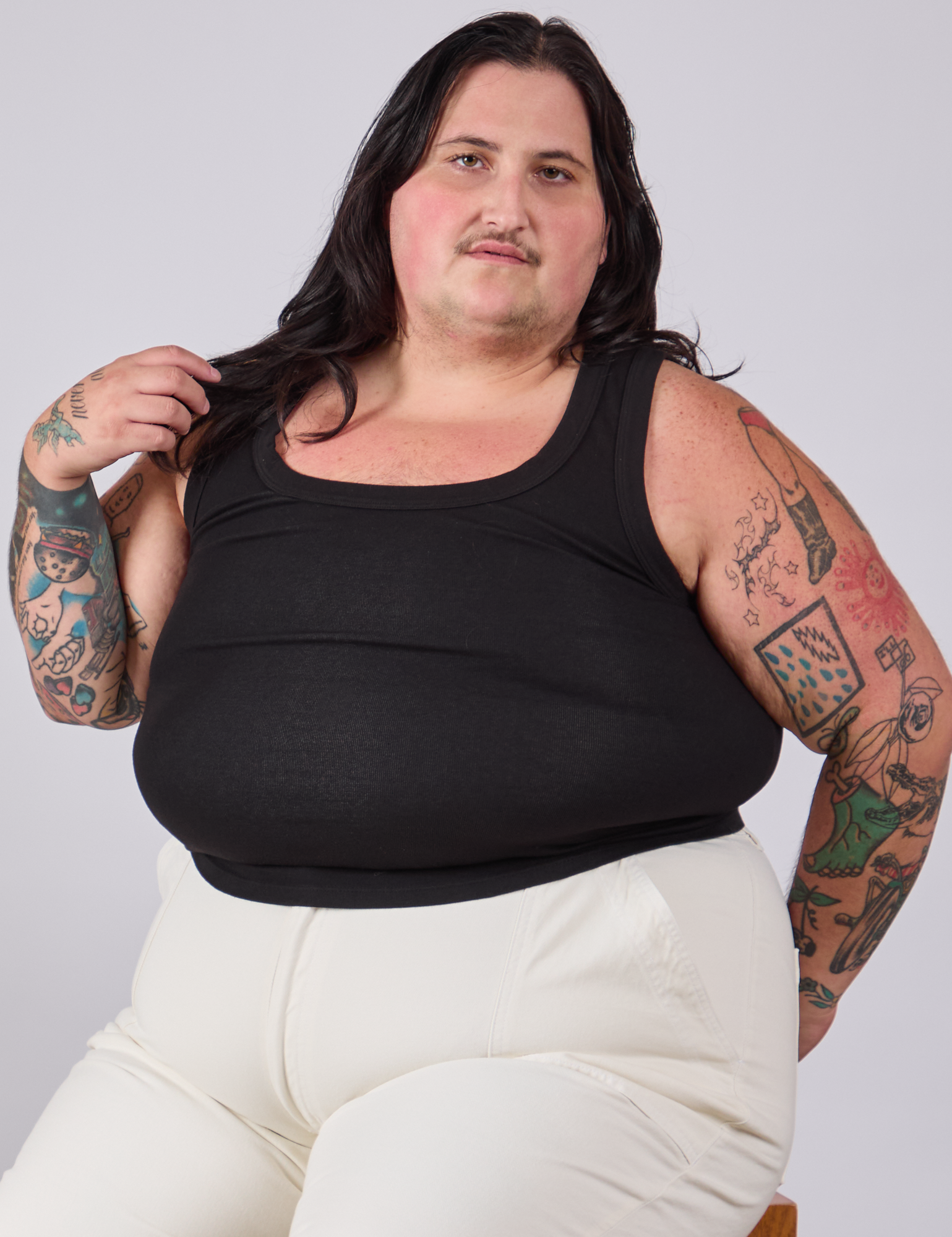 Sam is wearing Tank Top in Basic Black