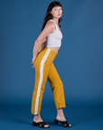 Side view of Painted Work Pants in Mustard Yellow and vintage tee white Cropped Tank