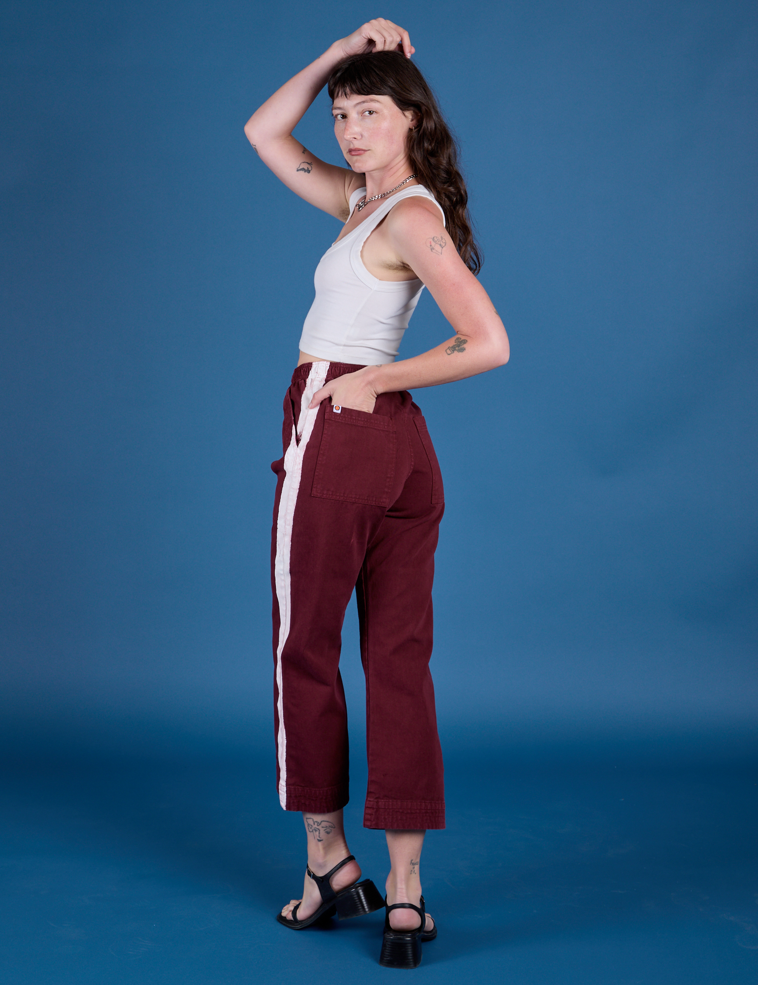 Painted Action Pants in Red Wine angled back view on Alex