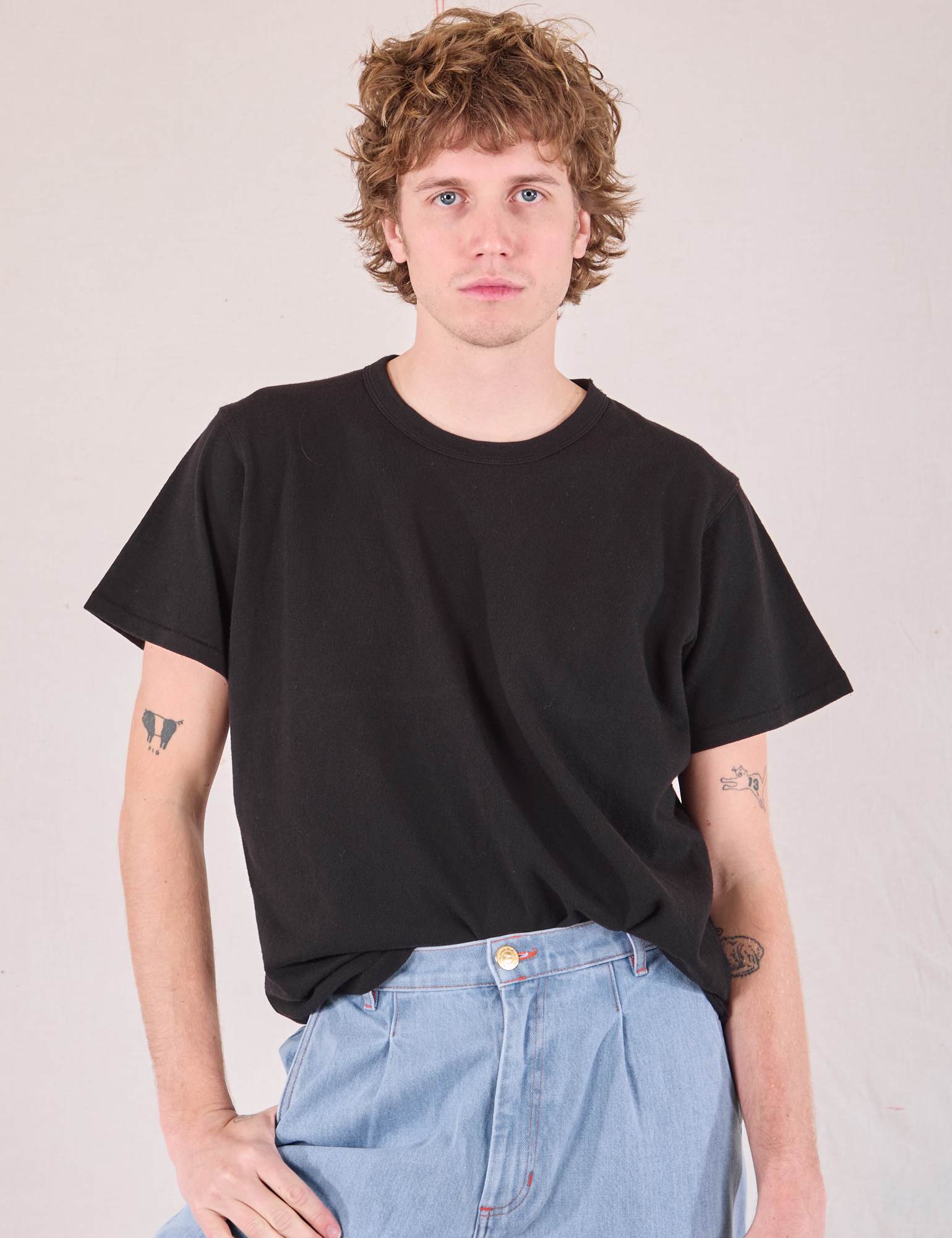 Burly Tee in Basic Black tucked into light wash Denim Wide Leg Trousers on Quinn