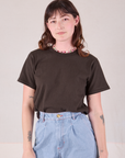 Alex is wearing Burly Tee in Espresso Brown tucked into light wash Denim Wide Leg Trousers