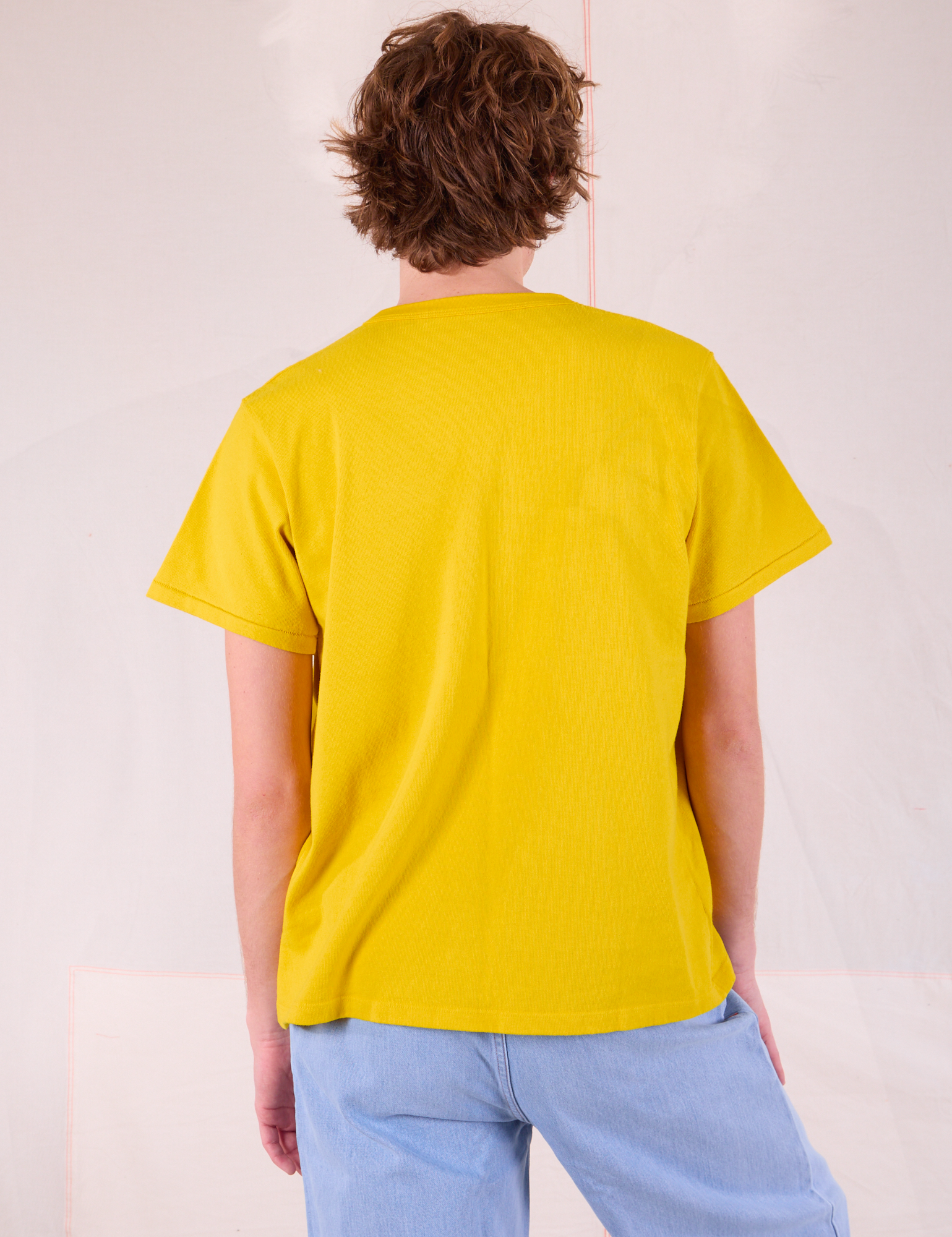 Burly Tee in Golden Yellow back view on Quinn