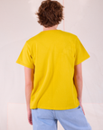 Burly Tee in Golden Yellow back view on Quinn