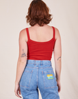 Back view of Cropped Cami in Mustang Red and light wash Frontier Jeans worn by Alex