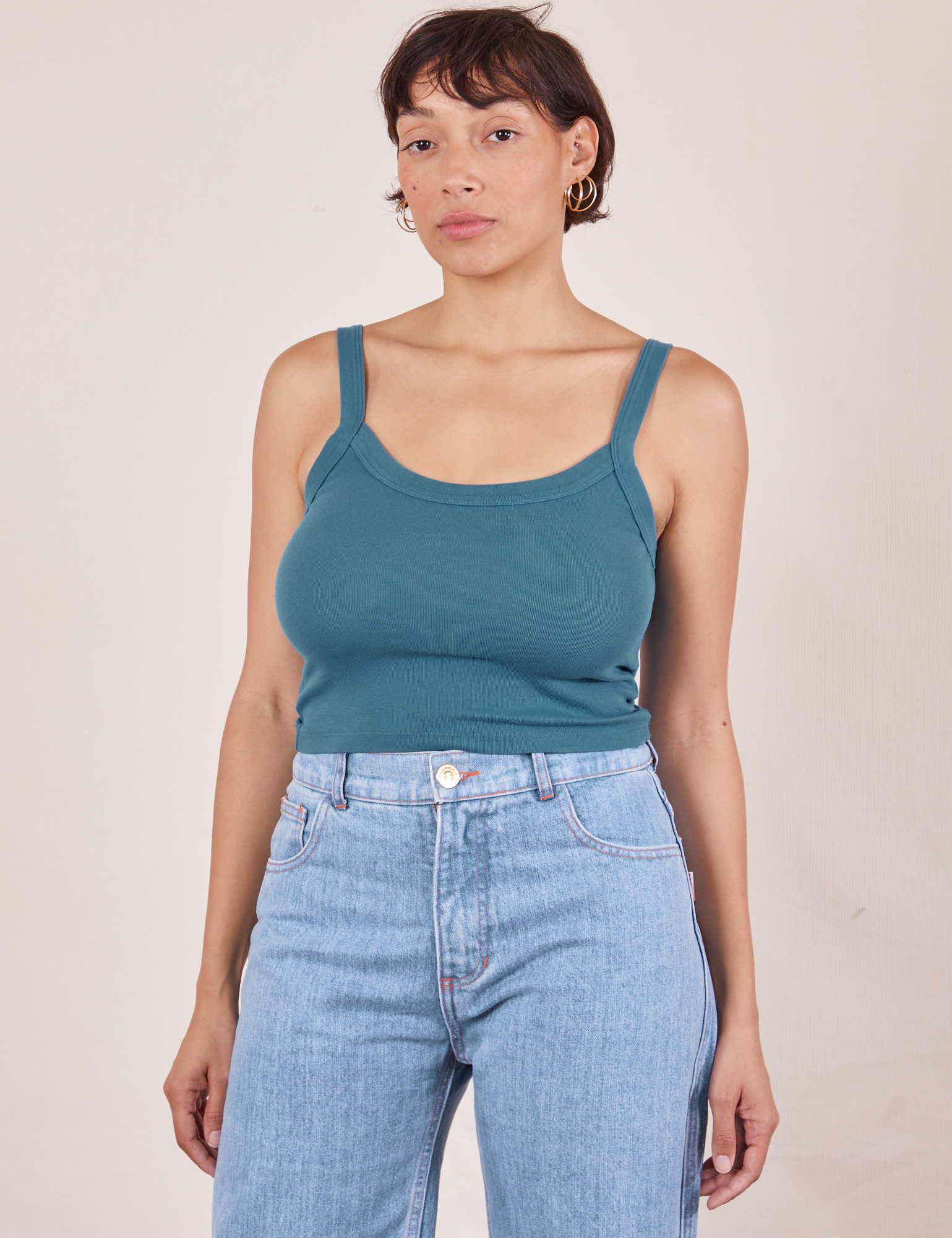 Tiara is 5&#39;4&quot; and wearing XS Cropped Cami in Marine Blue paired with light wash Sailor Jeans