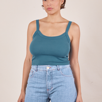 Tiara is 5'4" and wearing XS Cropped Cami in Marine Blue paired with light wash Sailor Jeans