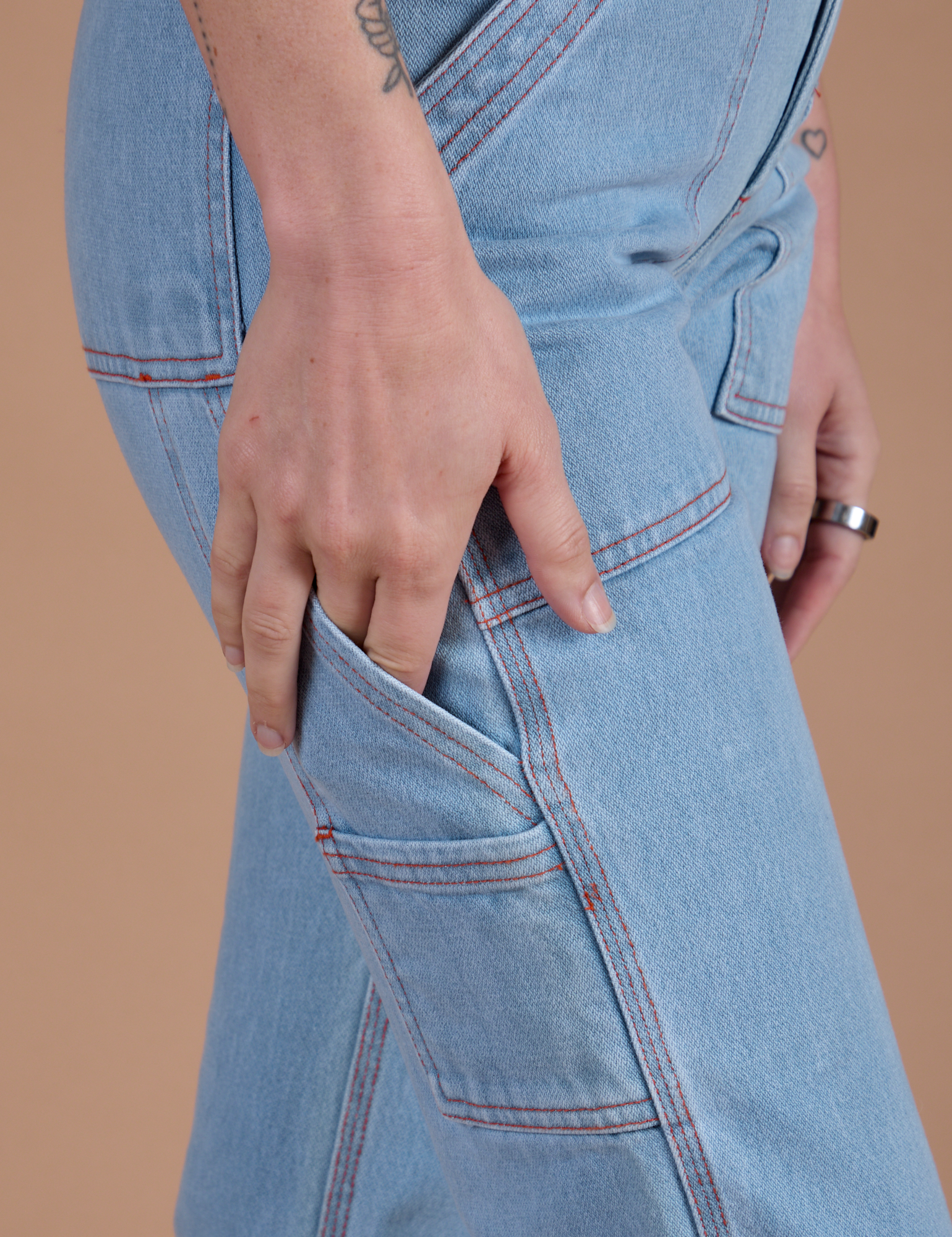 Carpenter Jeans in Light Wash side view pant leg close up on Alex