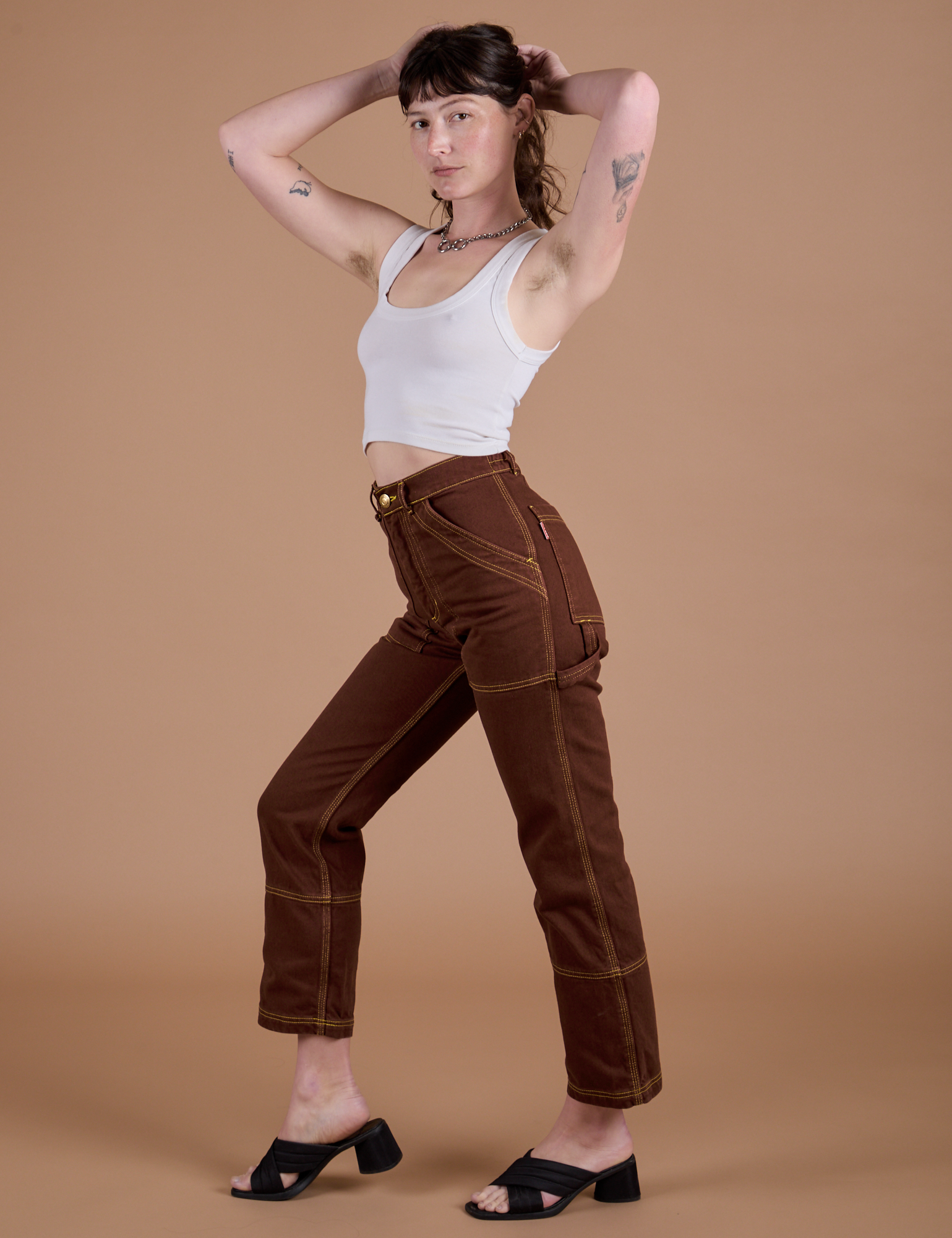 Angled front view of Carpenter Jeans in Fudgesicle Brown on Alex