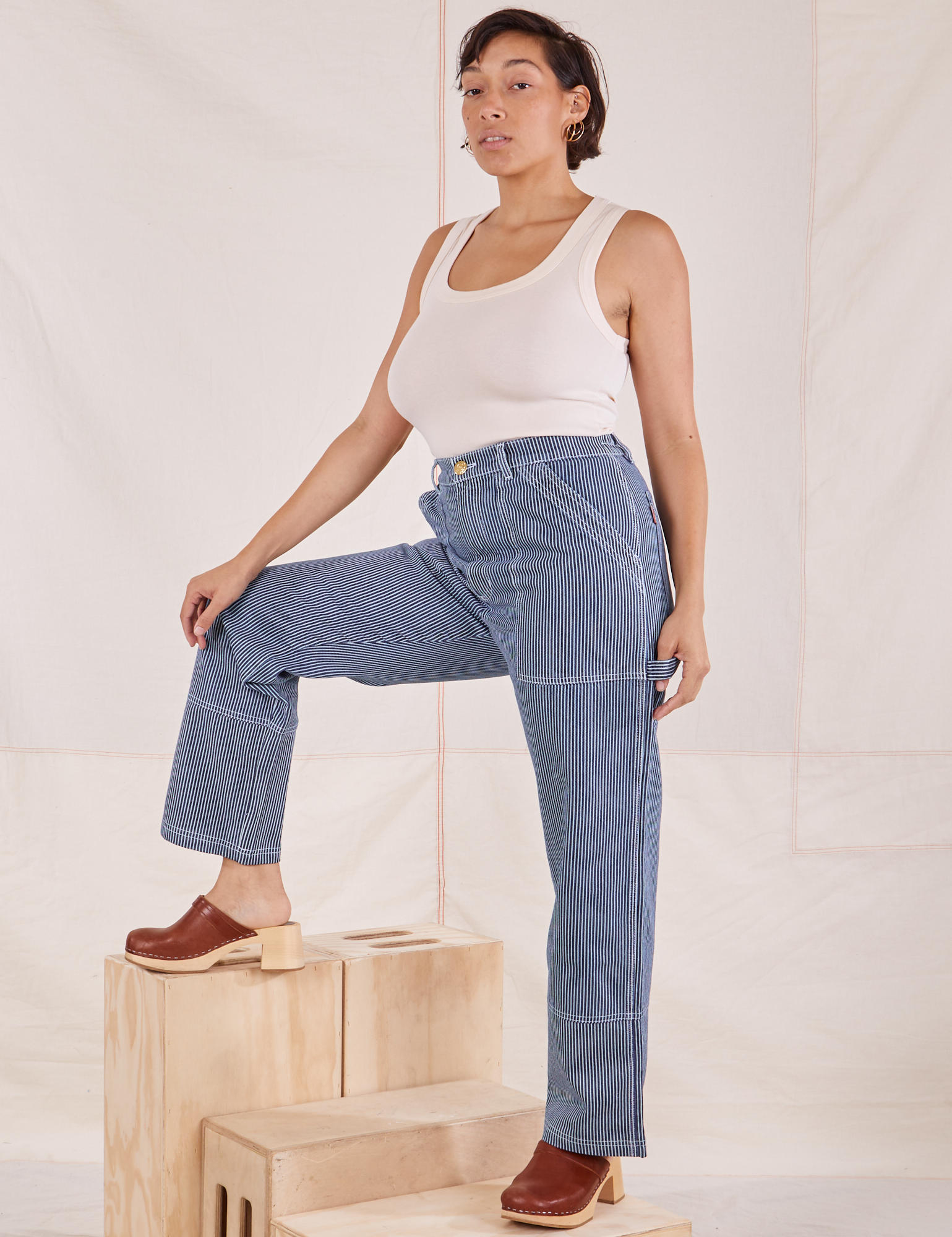 Tiara is wearing Carpenter Jeans in Railroad Stripes and vintage off-white Tank Top
