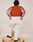 Back view of Carpenter Jeans in Vintage Off-White and burnt terracotta Cropped Tank Top on Sam