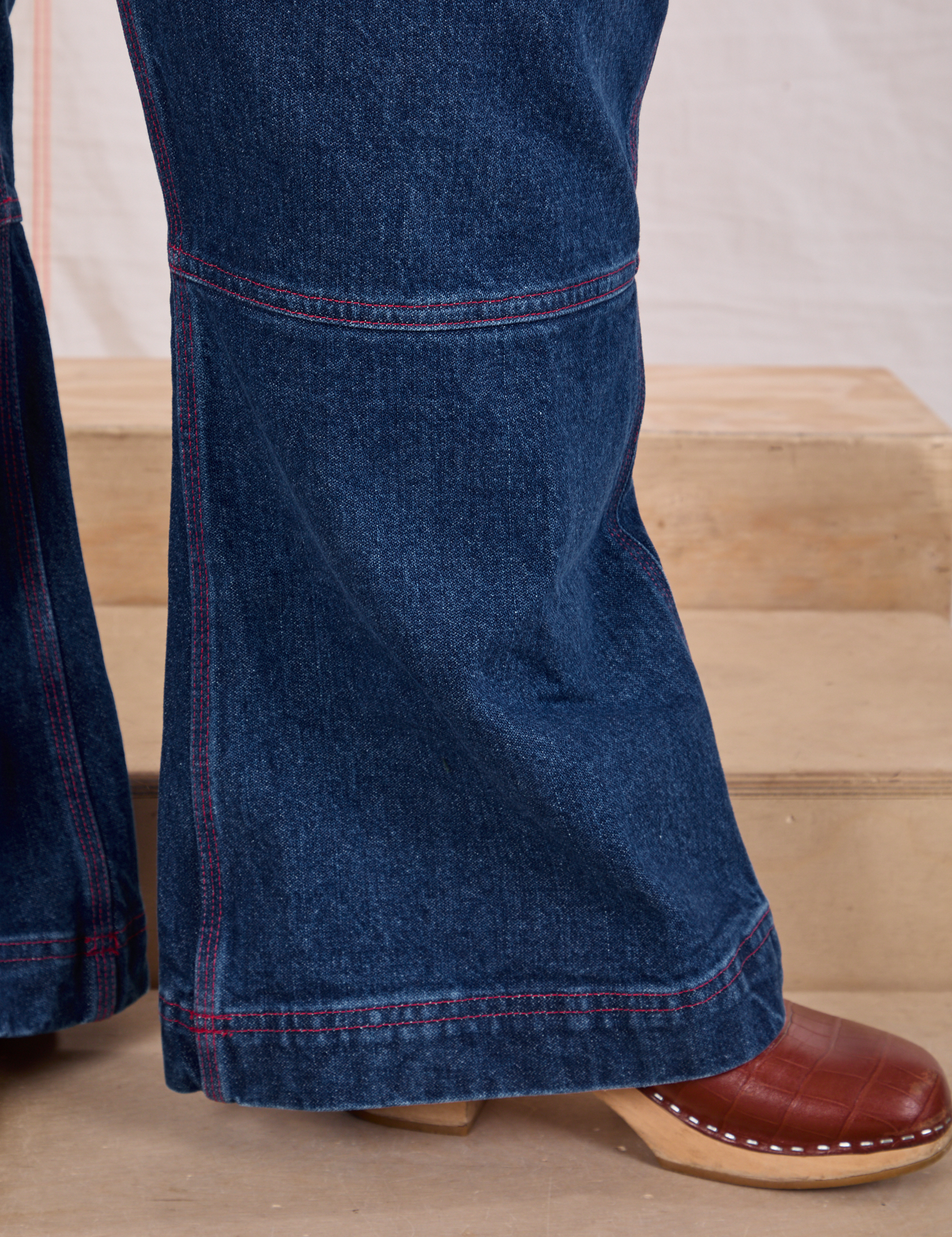 Carpenter Overalls in Dark Wash close up of flared pant leg on Ashley