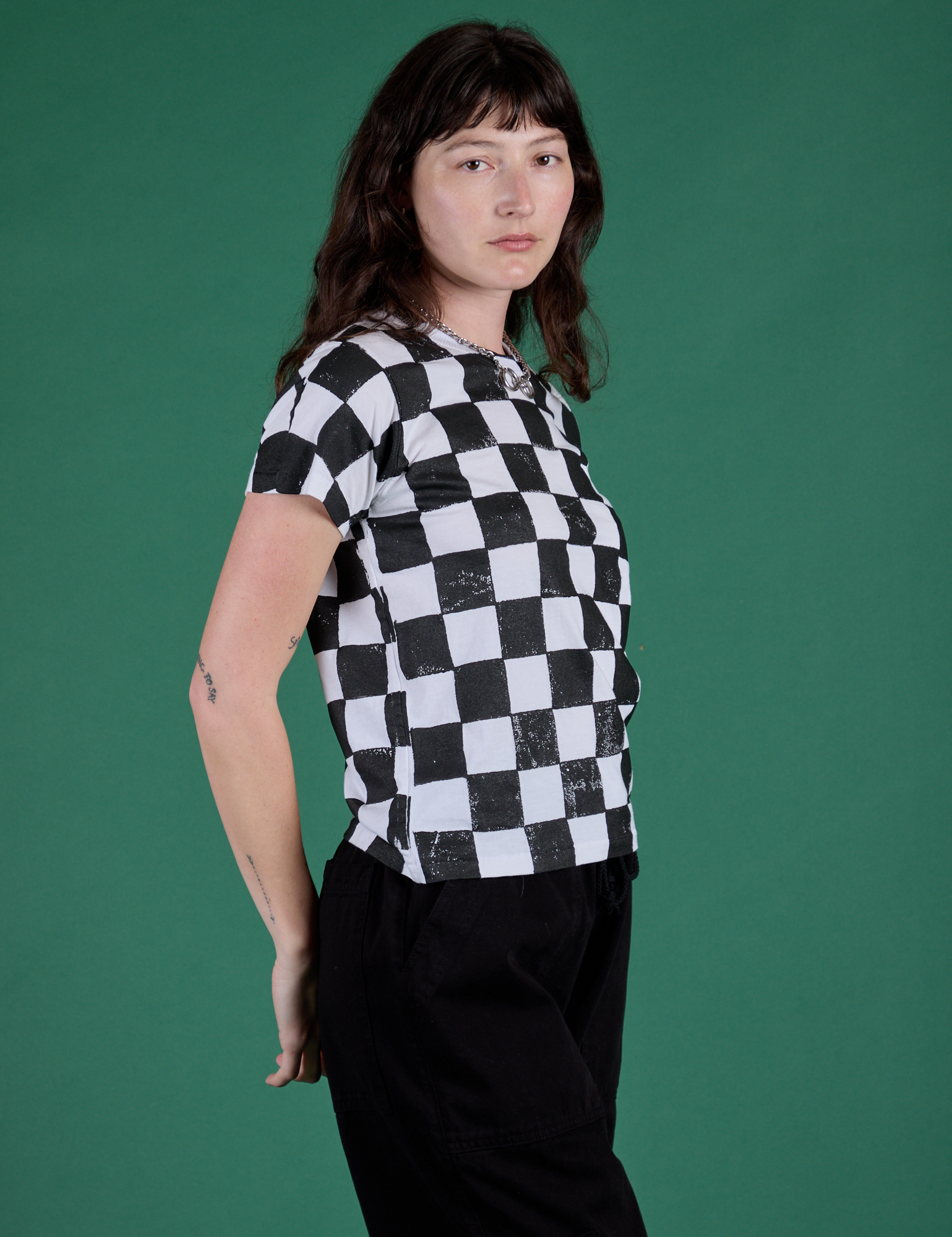 Angled front view of Checker Organic Tee in Black on Alex