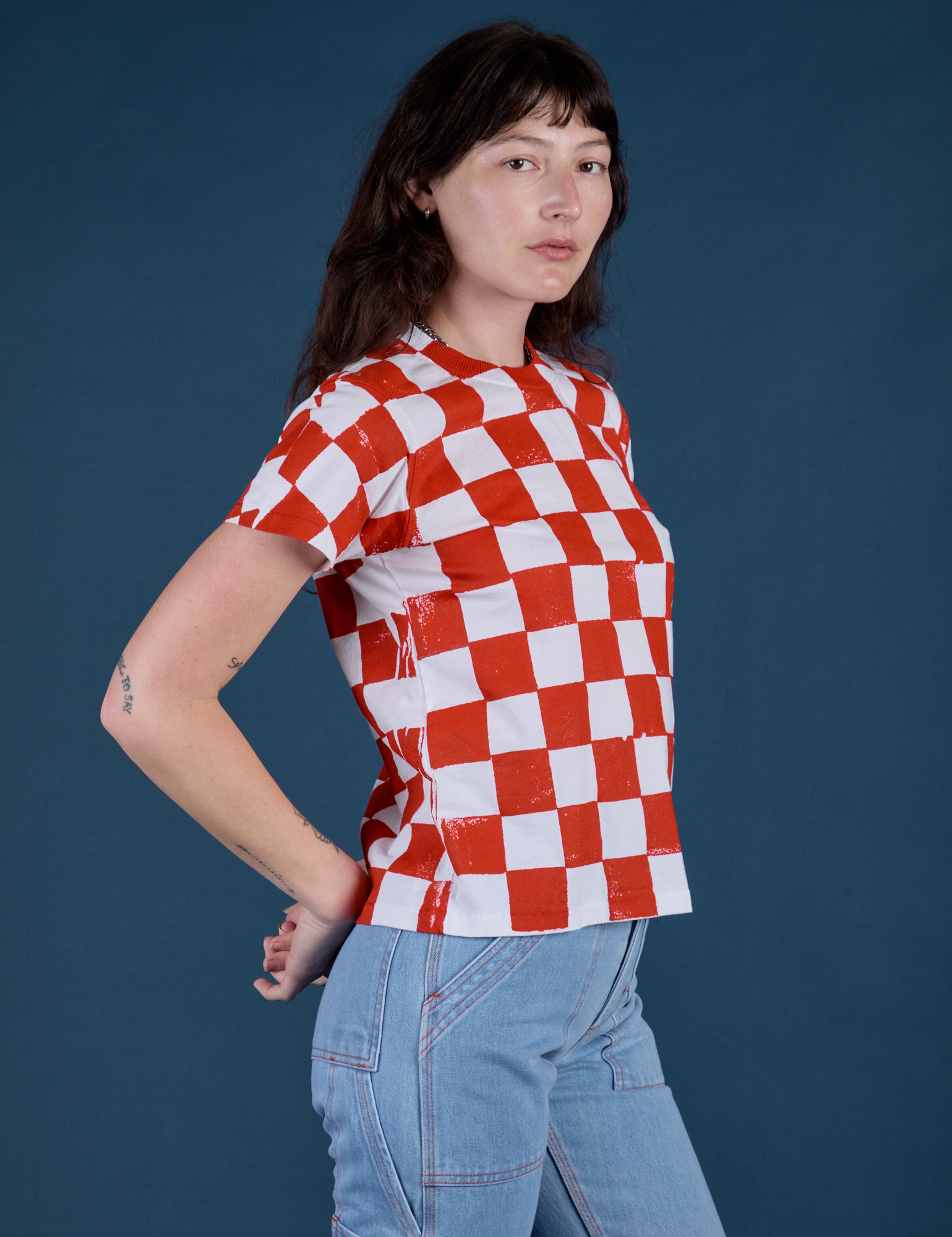 Angled front view of Checker Organic Tee in Red on Alex