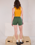 Back view of Painted Stripe Easy Shorts in Dark Emerald Green and golden yellow Cropped Tank on Alex
