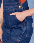 Indigo Denim Original Overalls in Dark Wash front pocket close up. Alex has her hand in the pocket.