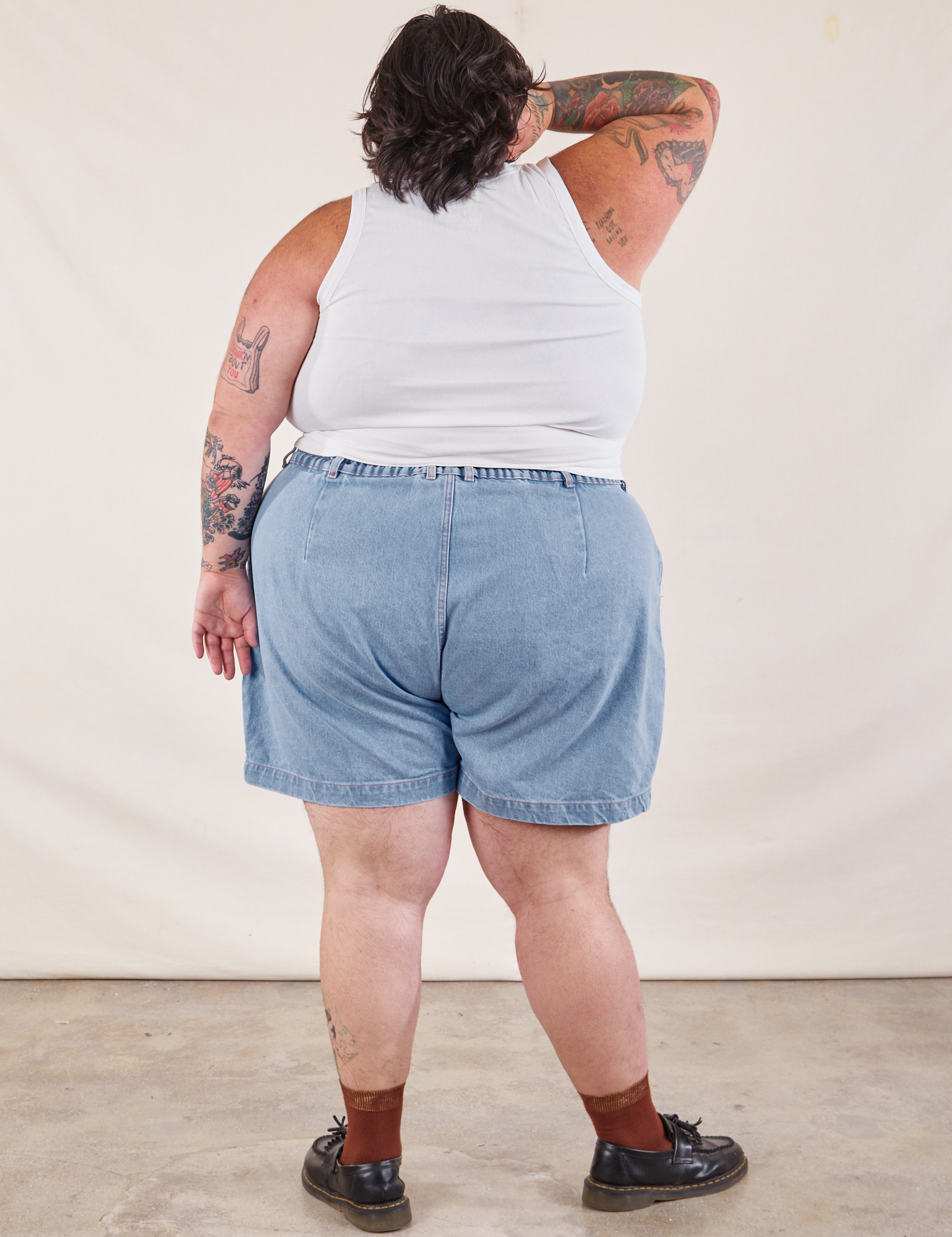 Back view of Denim Trouser Shorts in Light Wash and Cropped Tank in vintage tee off-white