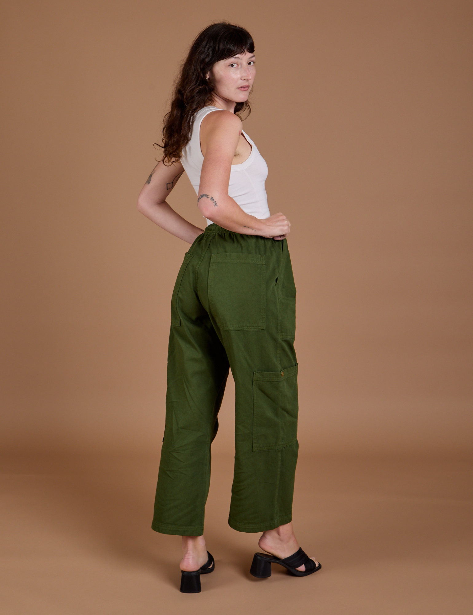 Angled back view of Drop Pocket Cargo Pants in Evergreen on Alex