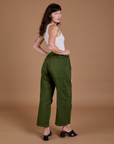 Angled back view of Drop Pocket Cargo Pants in Evergreen on Alex